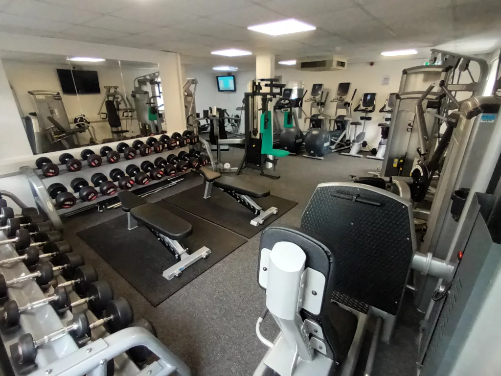 Benches, dumbbells, and leg extensions alt view